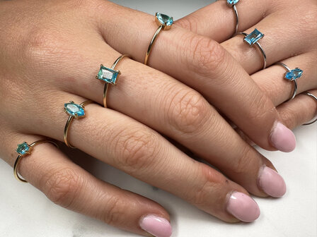 Charmin&#039;s Gold-Colored Ring with Elliptical Light Blue Crystal R1689&ndash; Summer in Style